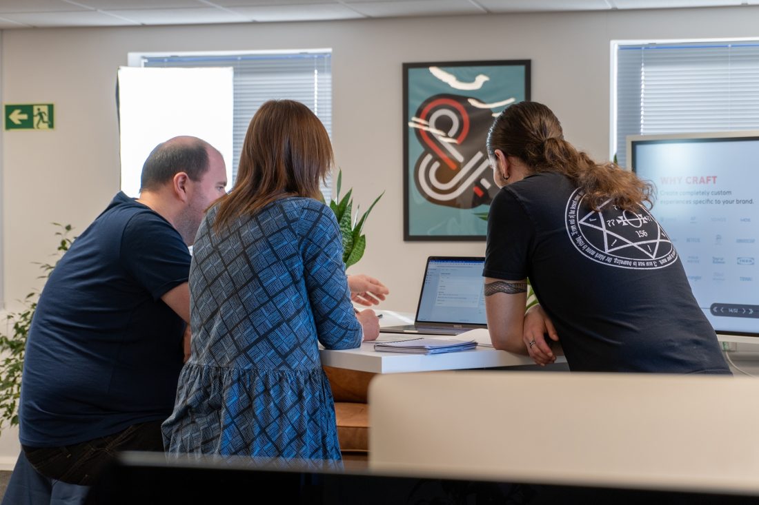 Our in-house web development team working around a laptop