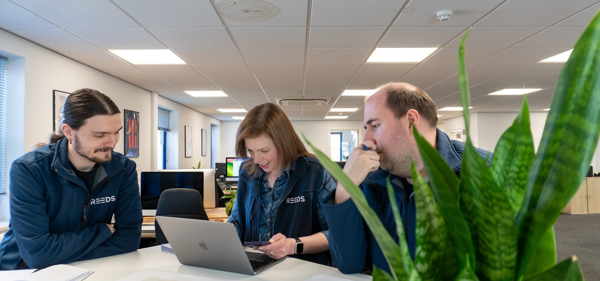 Luke, Judith, and Chris reviewing work