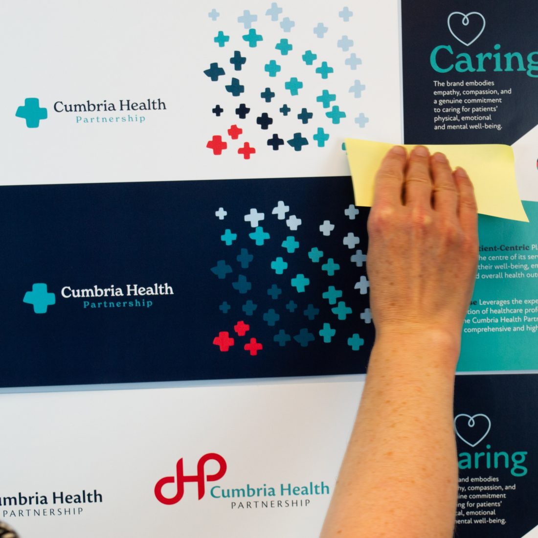 Reeds team reviewing design mockups of Cumbria Healths new logo design