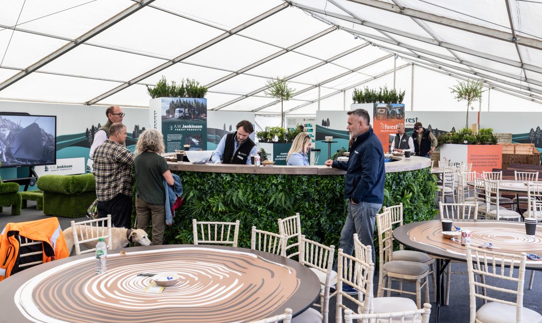 People enjoying the exhibition space, featuring the tailored table coverings