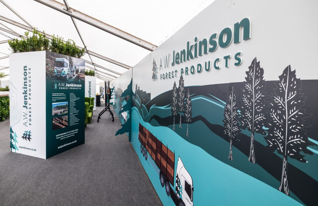 A planter on the left and the AW Jenkinson mural, featuring a logging truck, on the right