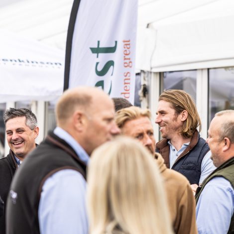 A crowd of people socialising at the exhibition