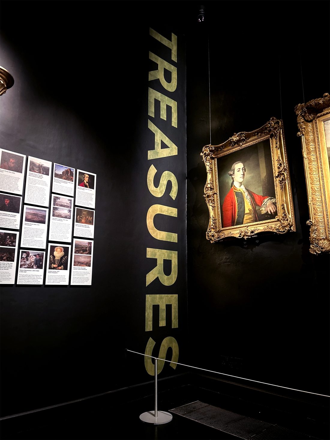 The Story of Lowther exhibition, typographic gold wall vinyl, vertically reads 'TREASURES'.