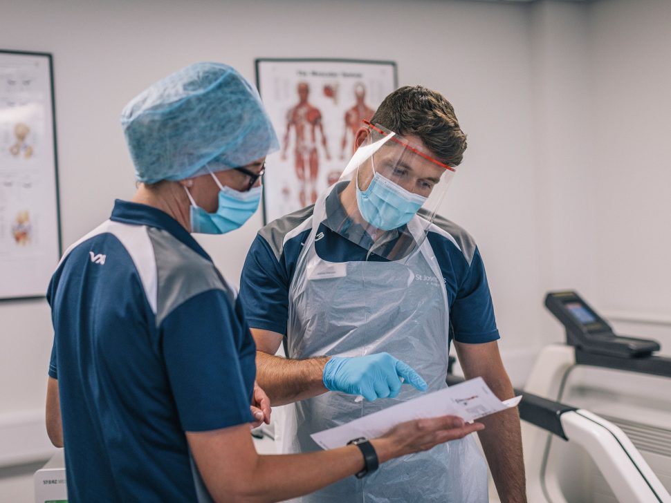 Two staff wearing PPE