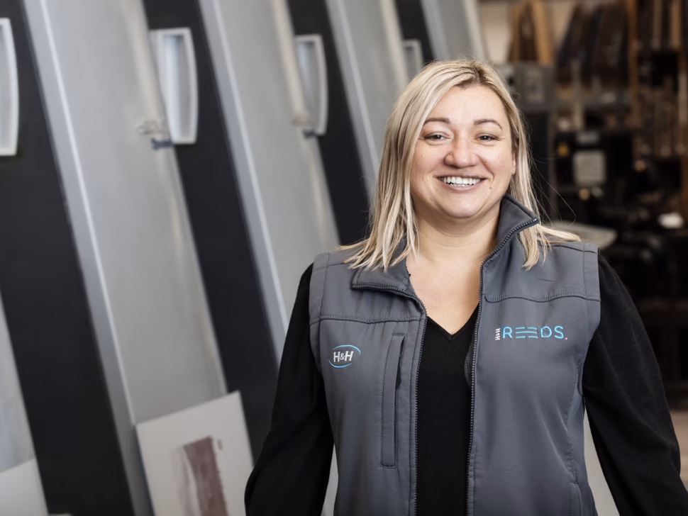 Sasha standing in front of the Litho printer in Penrith