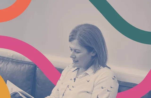 Becca Davidson, reading a branding book she designed at Reeds.