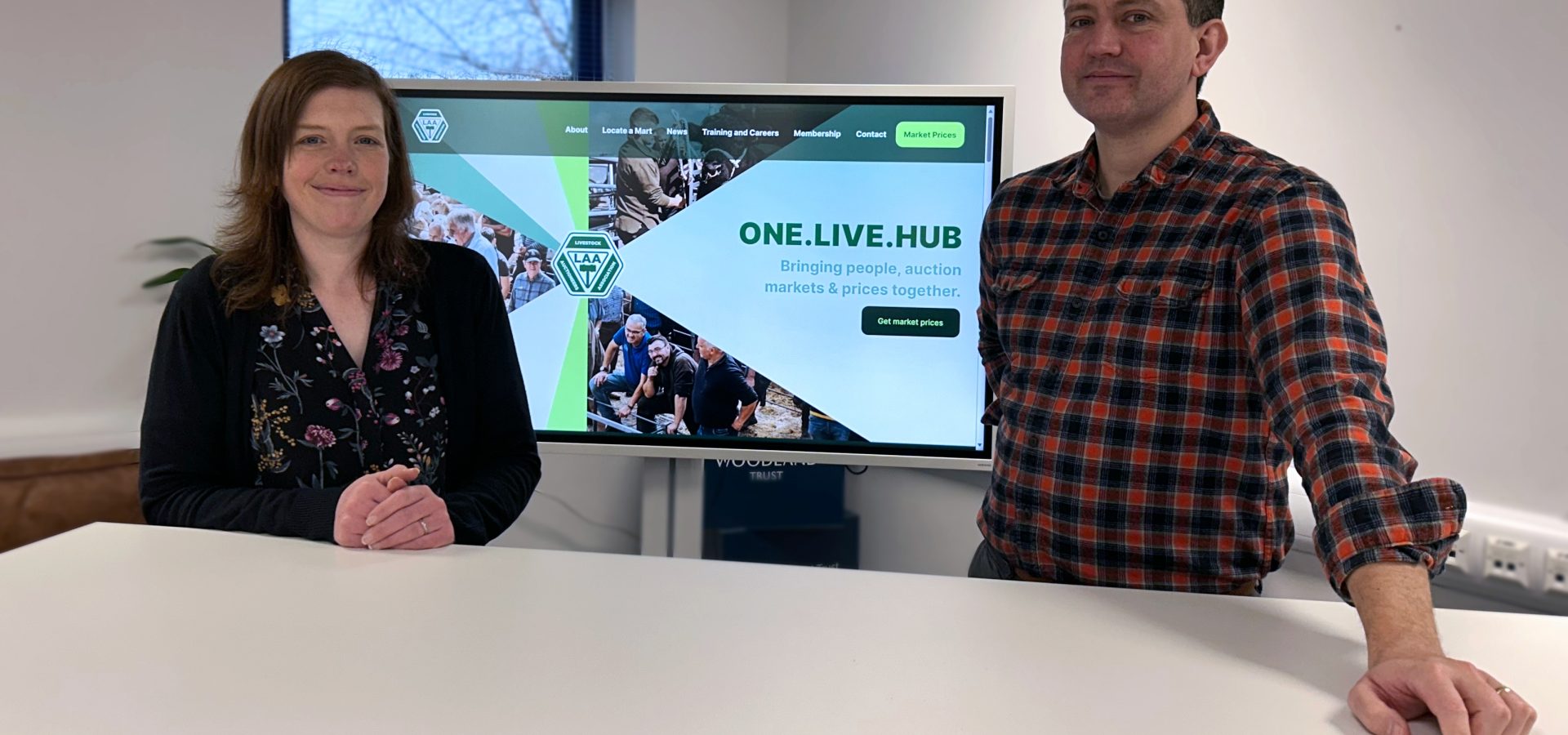 Steven Hart, Head of Web Design and Judith Sutherland, Head of Web Development posing in front of the Livestock Auctioneers Association brand new website by Reeds.