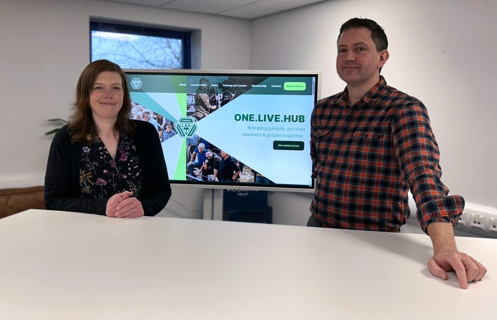 Steven Hart, Head of Web Design and Judith Sutherland, Head of Web Development posing in front of the Livestock Auctioneers Association brand new website by Reeds.