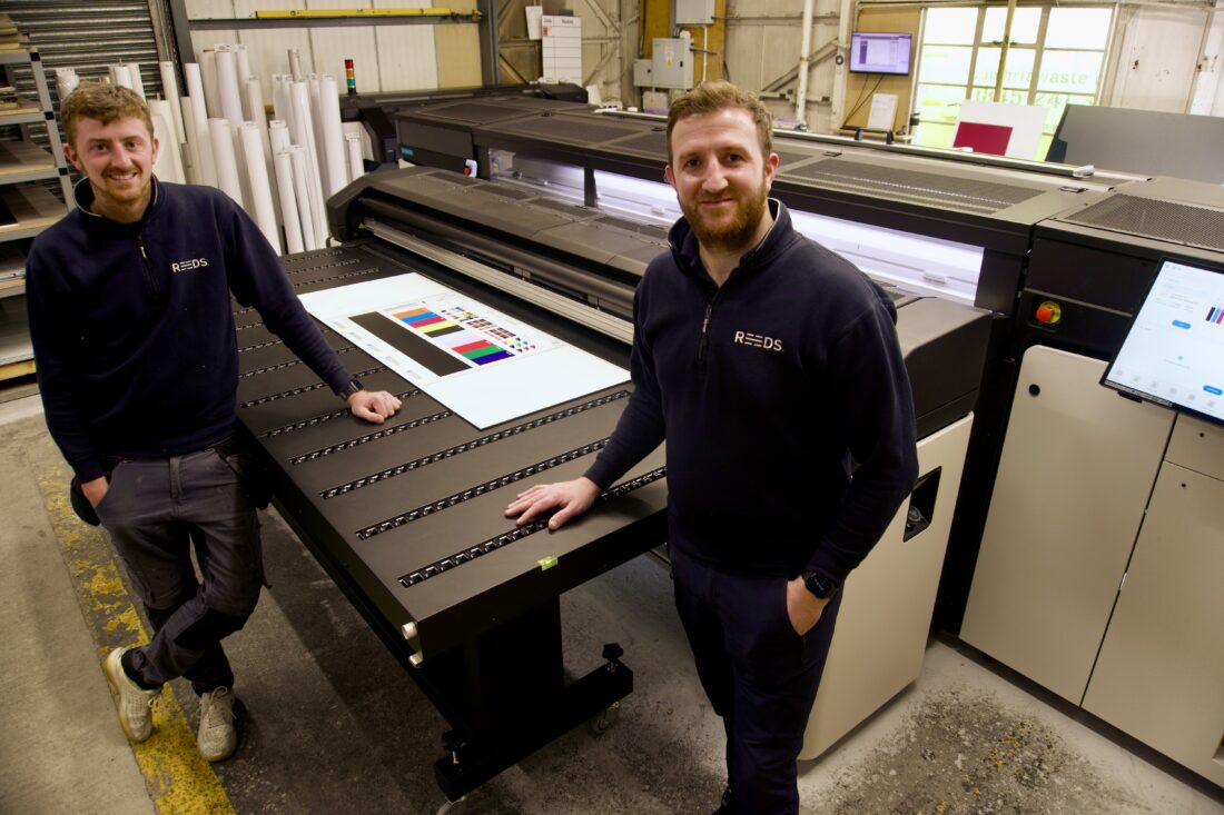 Marco and Andy infront of the HP Latex R2000 wide-format printer.