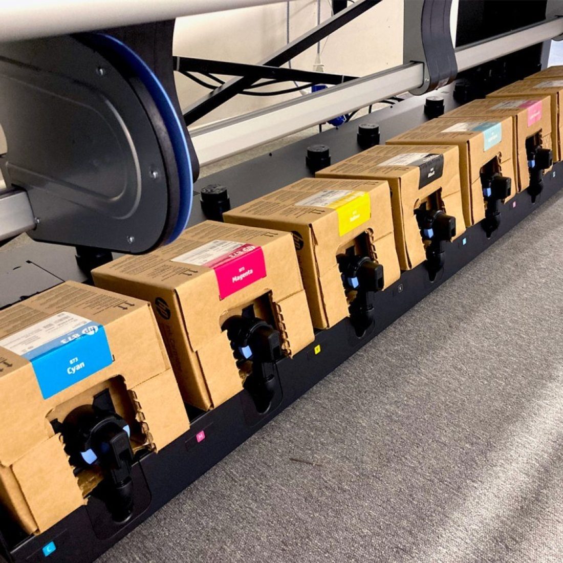 Large format printer images focus on the boxes of ink