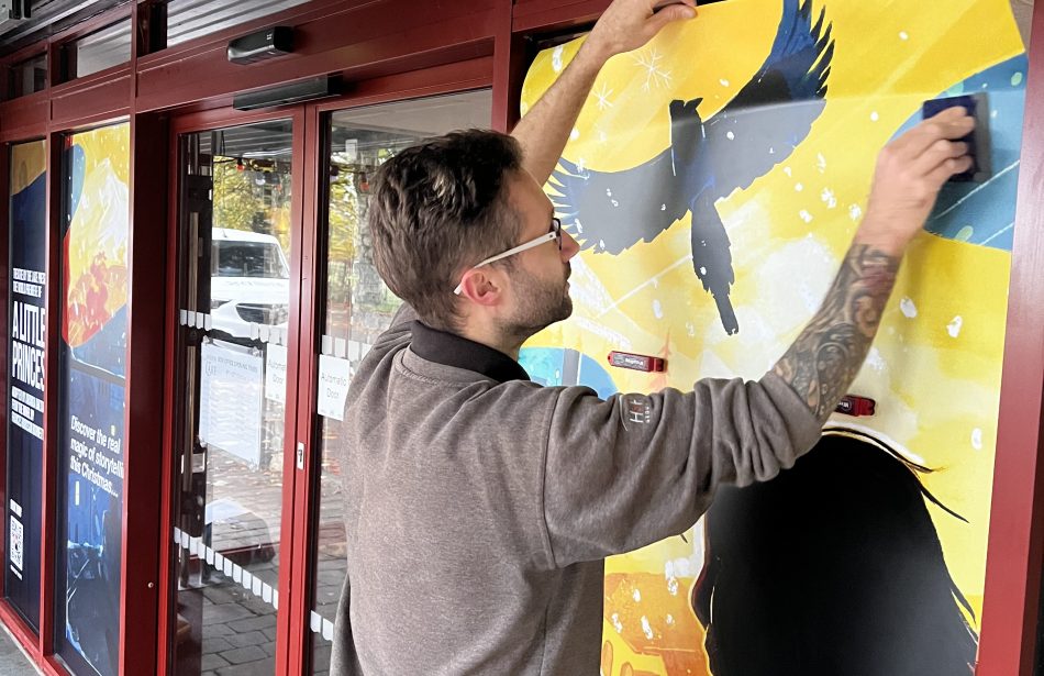 Theatre by the lake window graphic being installed